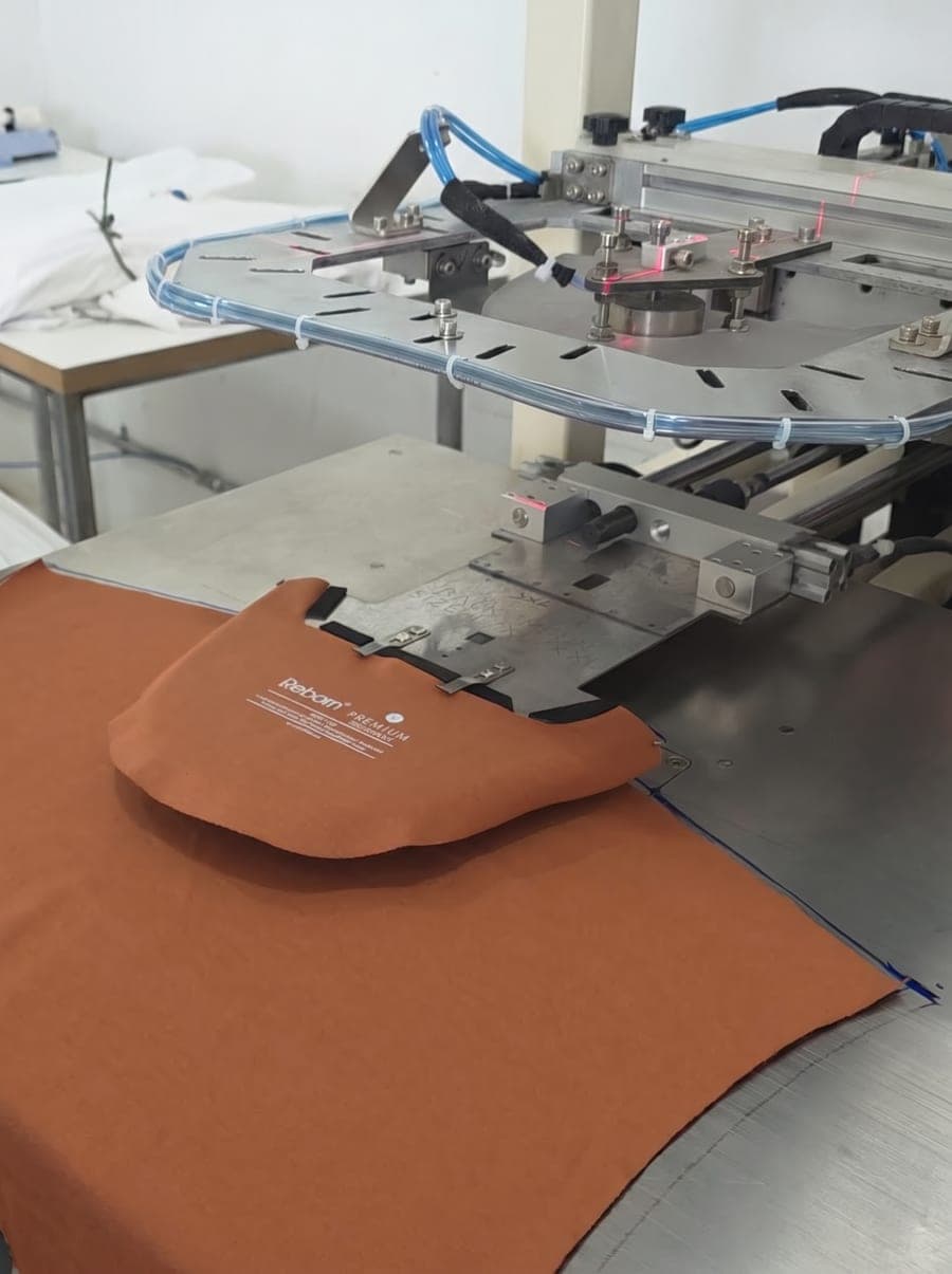 Automated heat-transfer branding applied to premium apparel